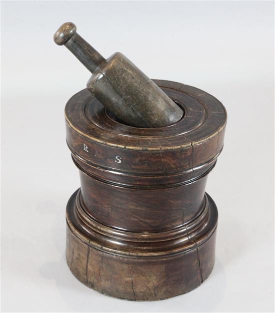 A George III lignum vitae gunpowder mixer, with RMS initials, the mortar height 15in., diameter 14in., pestle 12.5in.